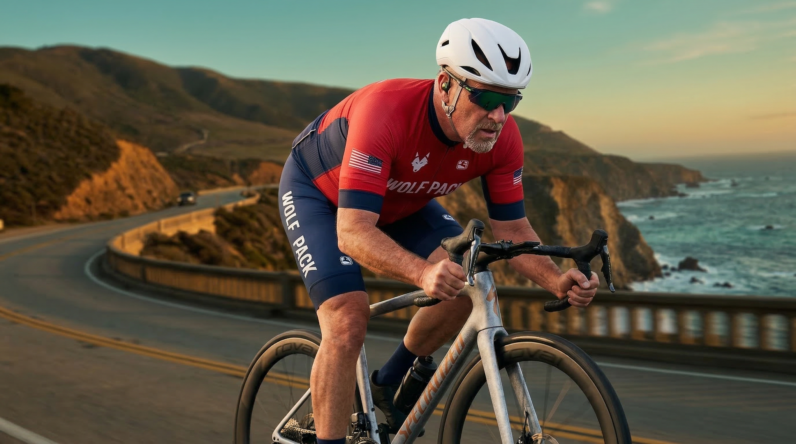Cyclist riding on a coastal California highway at golden hour